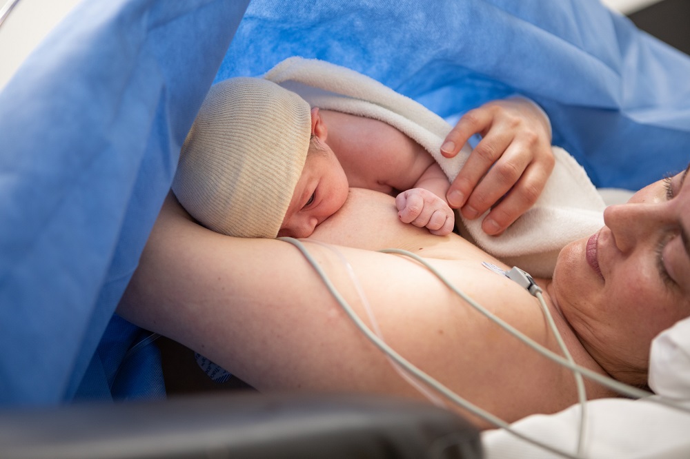 Mother breastfeeding her baby in hospital