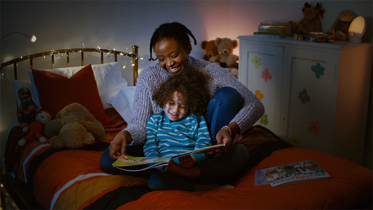 Mum reading stories to her child at bedtime