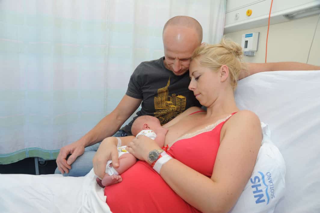 Mum and dad in hospital with newborn baby