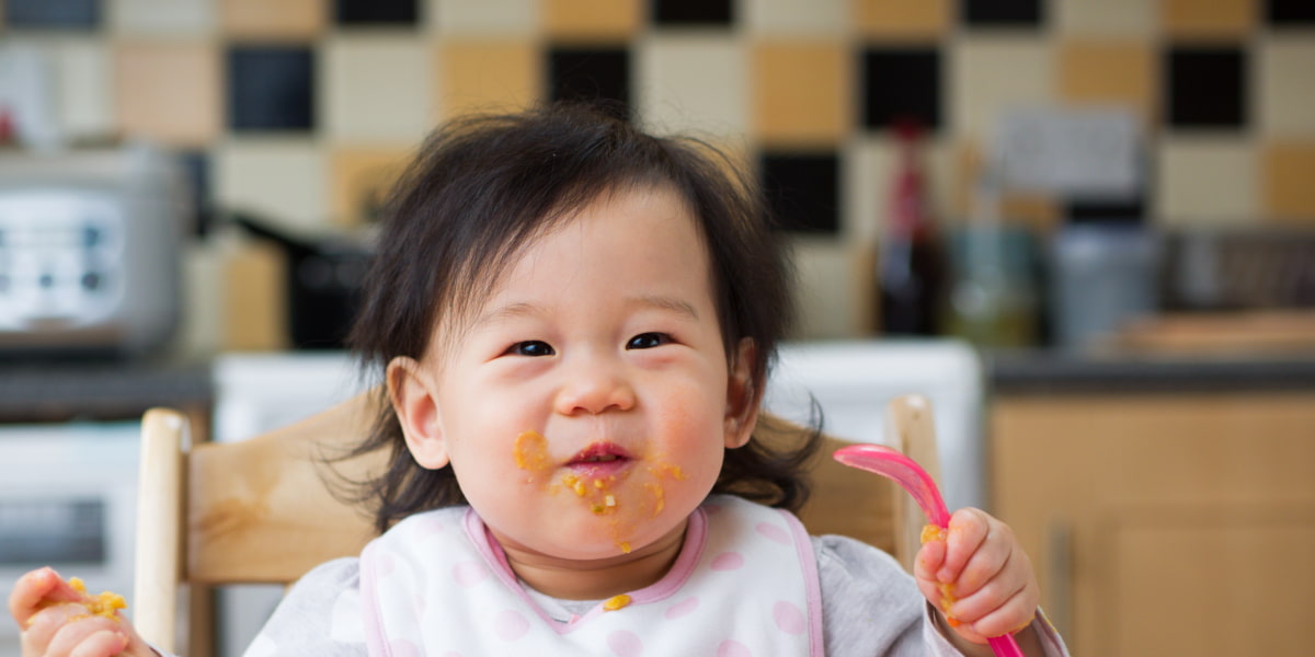 Toddler eating in the kitchen