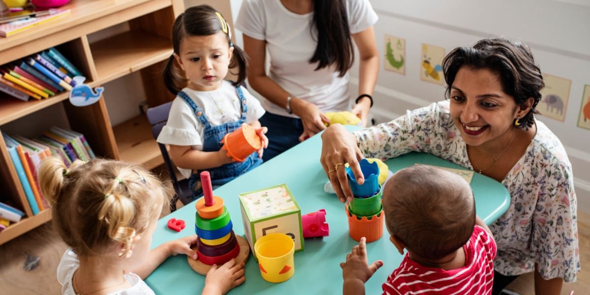 Toddlers playing with a nursery working