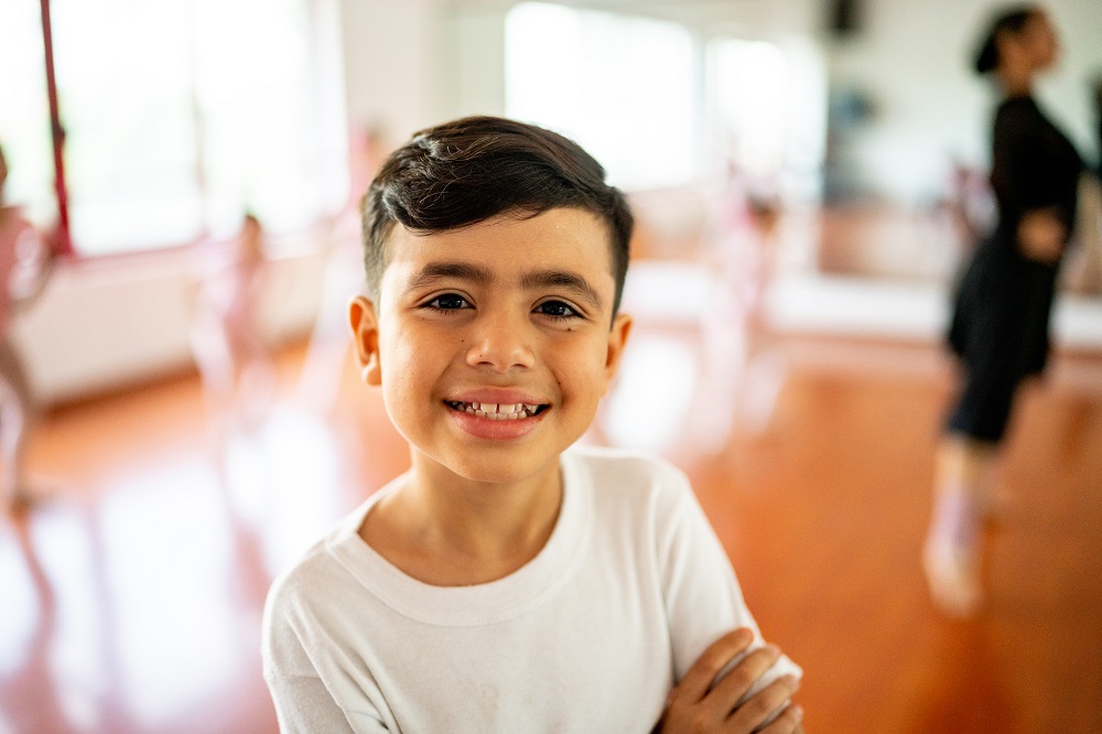 Smiling young boy in a ballet class
