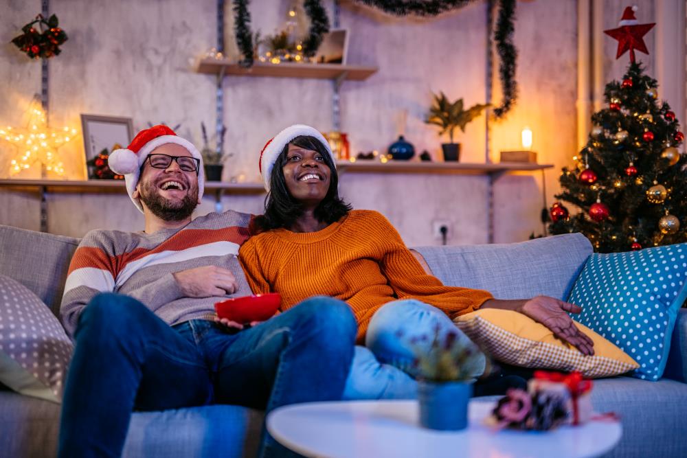 Couple relaxing on their sofa at Christmas time.