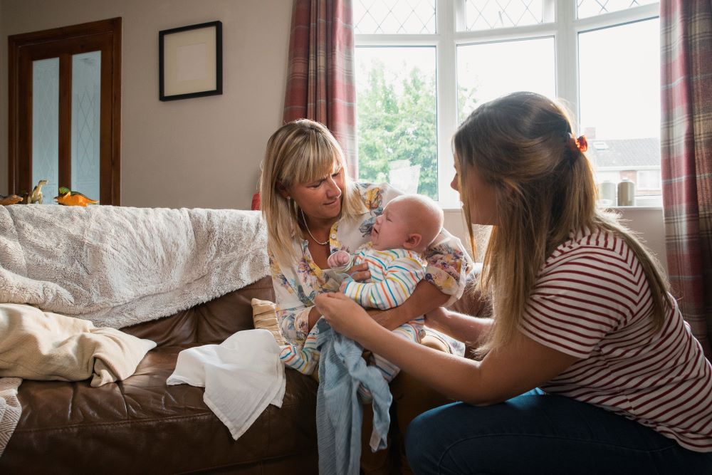 Mum and health visitor with baby.