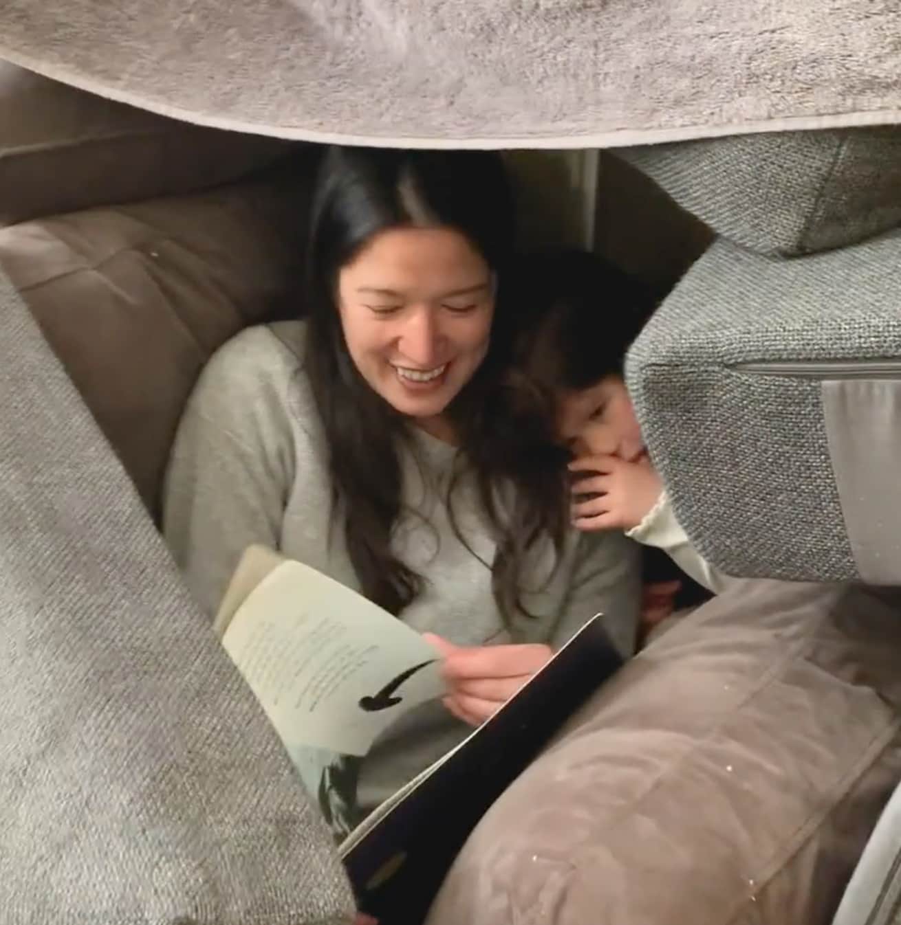 Photo of mum and child in pillow fort 
