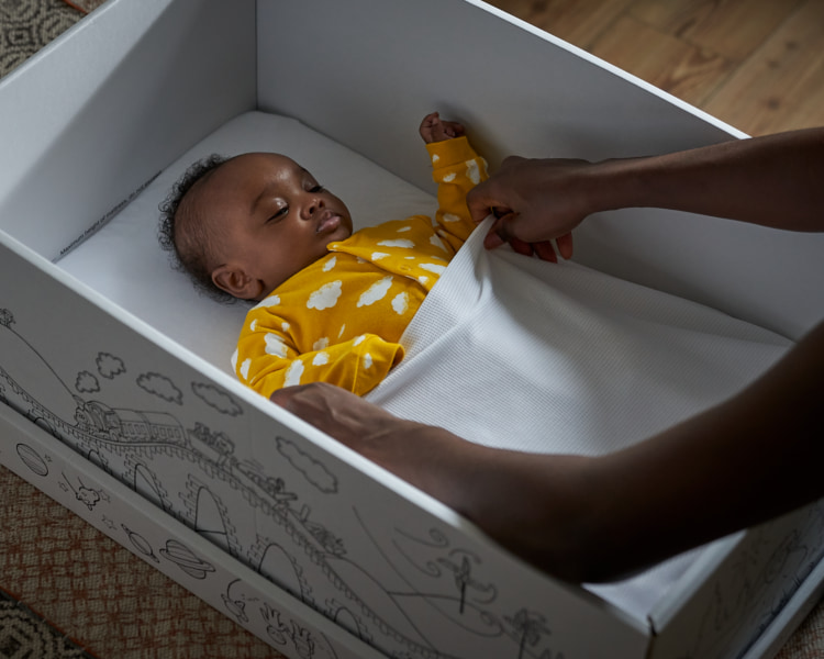 photo of baby sleeping in box