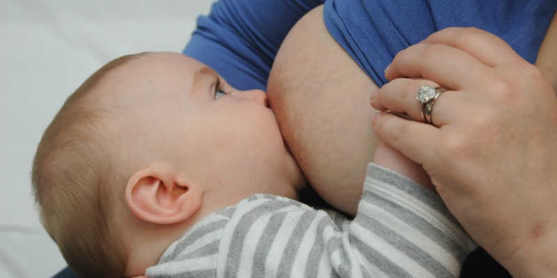 Photo of a baby suckling it mothers nipple