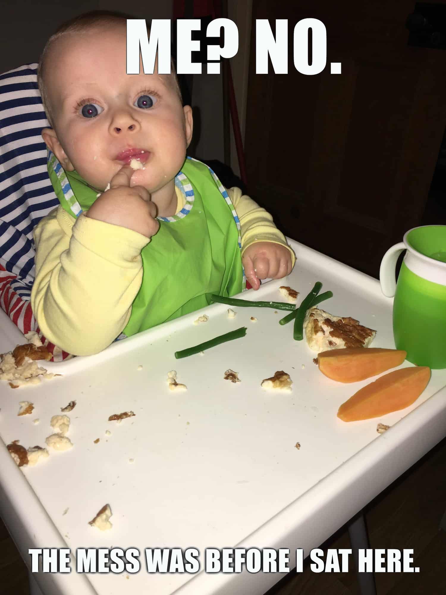 baby in highchair. Caption: me? no. this mess was before I sat here.