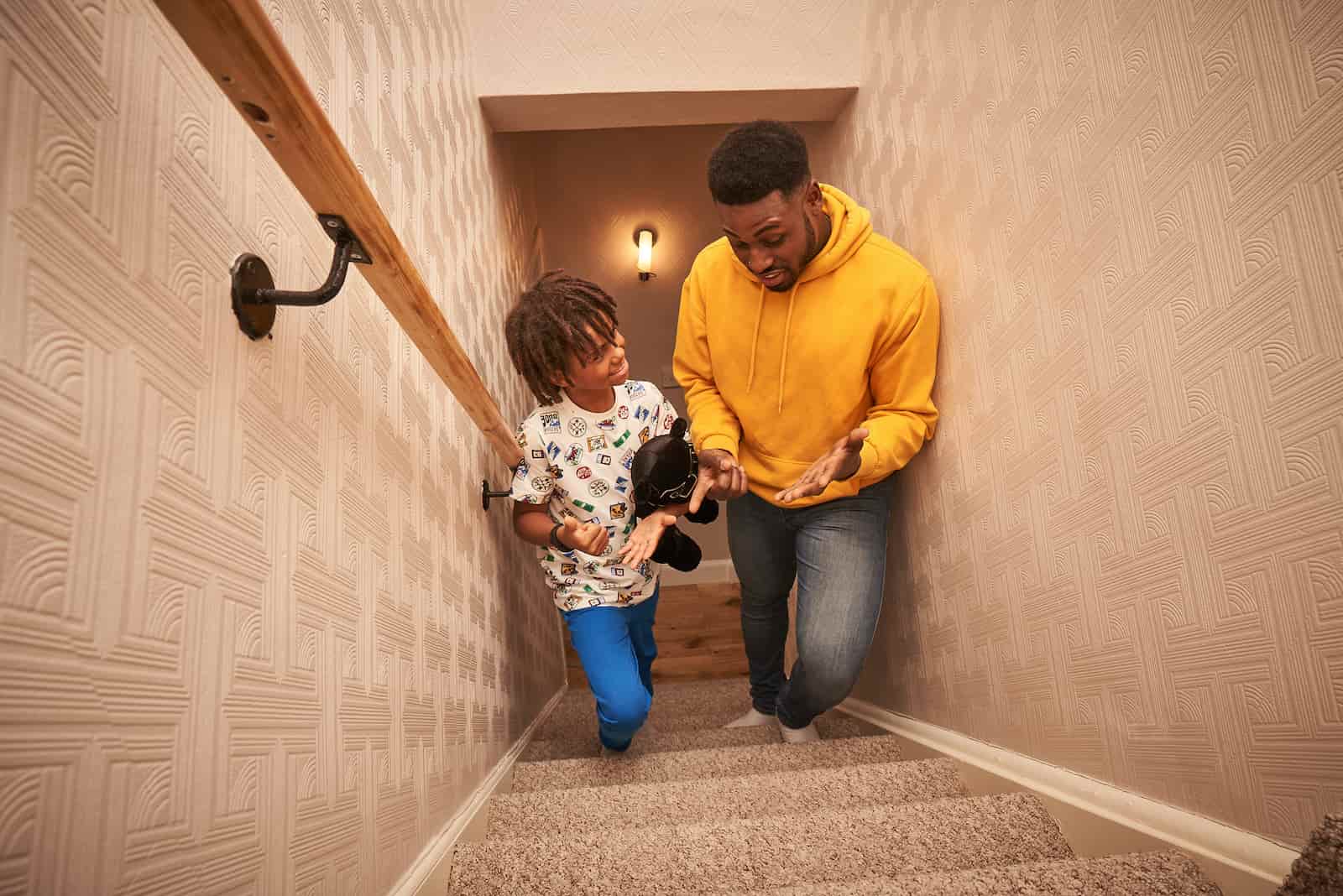 Image of a dad and child walking up a set of stairs together.
