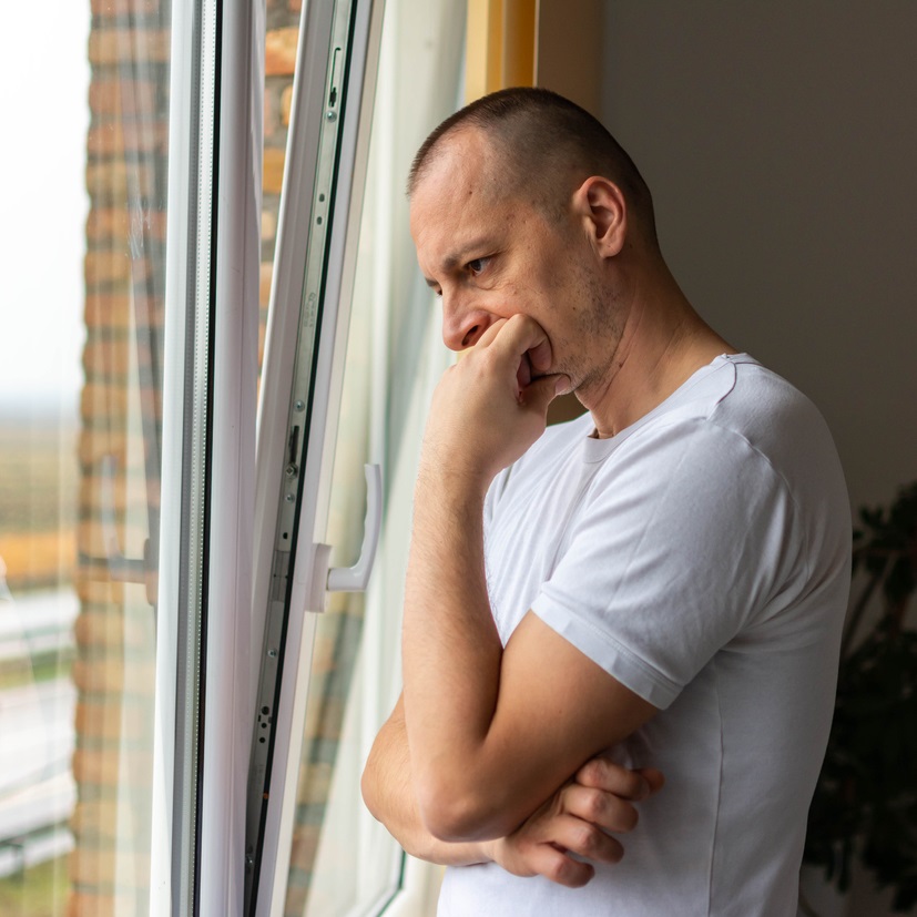 Man looking out of the window thoughtfully