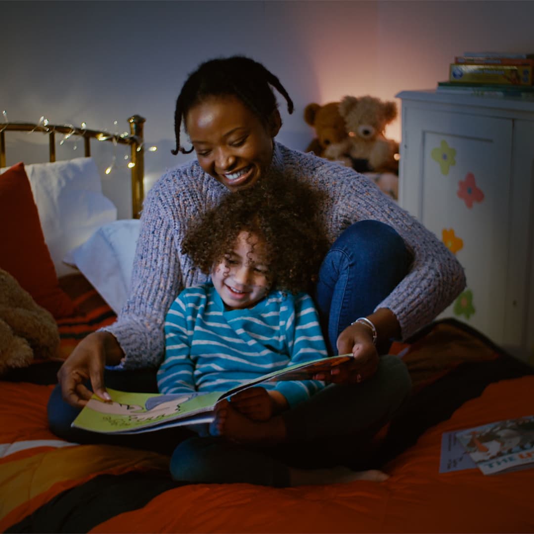 Mother and child reading a story together at bed time