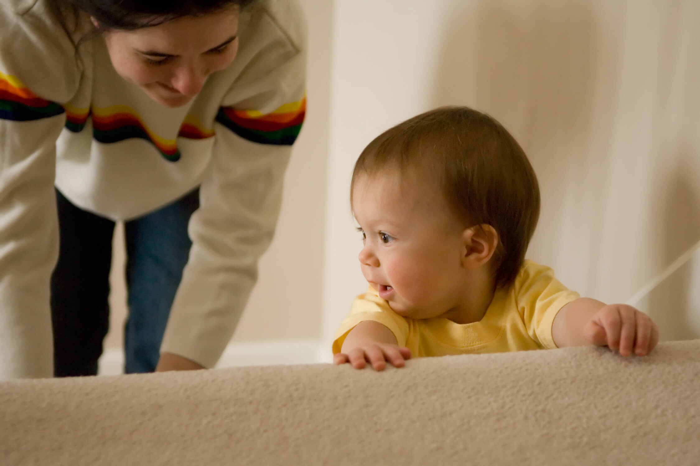 Photo of a baby climbing stairs with mum 