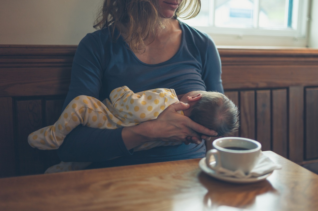 Mum breastfeeding her baby in a cafe