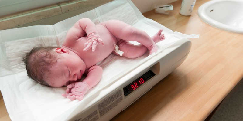 Photo of an underweight newborn baby on hospital scales