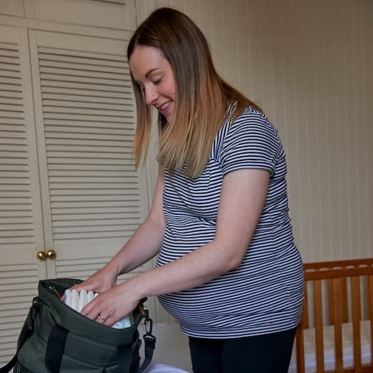 Pregnant mum packing an overnight bag