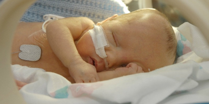 Photo of a premature baby sleeping in a hospital 
