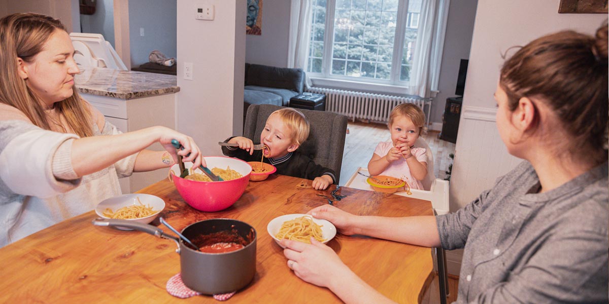Family with toddlers eating together