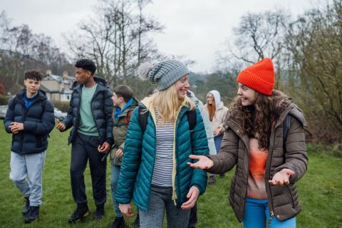 Teens outdoors talking and laughing