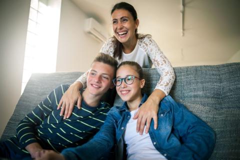 Mother with teen son and daughter, all smiling,