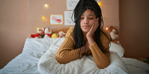 teen-girl-looking-sad-in-bedroom-banner