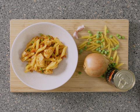 Bowl of chicken and pea pasta with ingredients