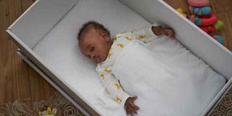photo of baby sleeping in box