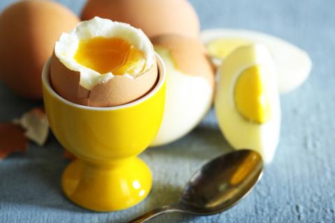 Boiled egg in a yellow egg cup