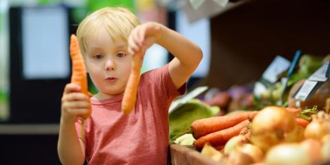 Photo of toddler shopping for carrots