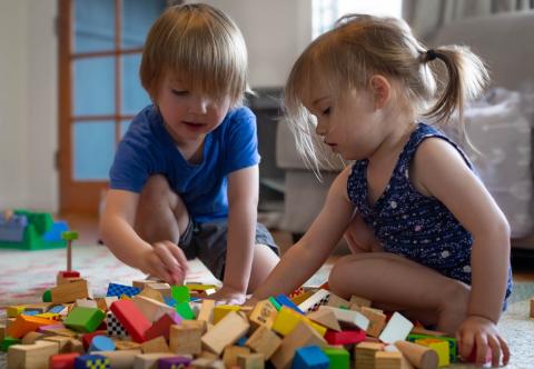 Toddlers playing together with blocks