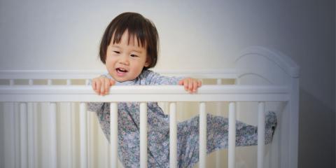 photo of toddler escaping cot