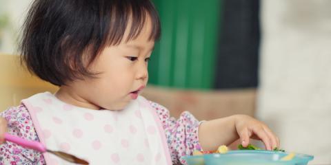 toddler eating from a bowl