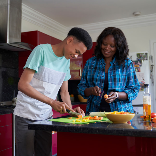 Photo of a teenager and mum cooking 