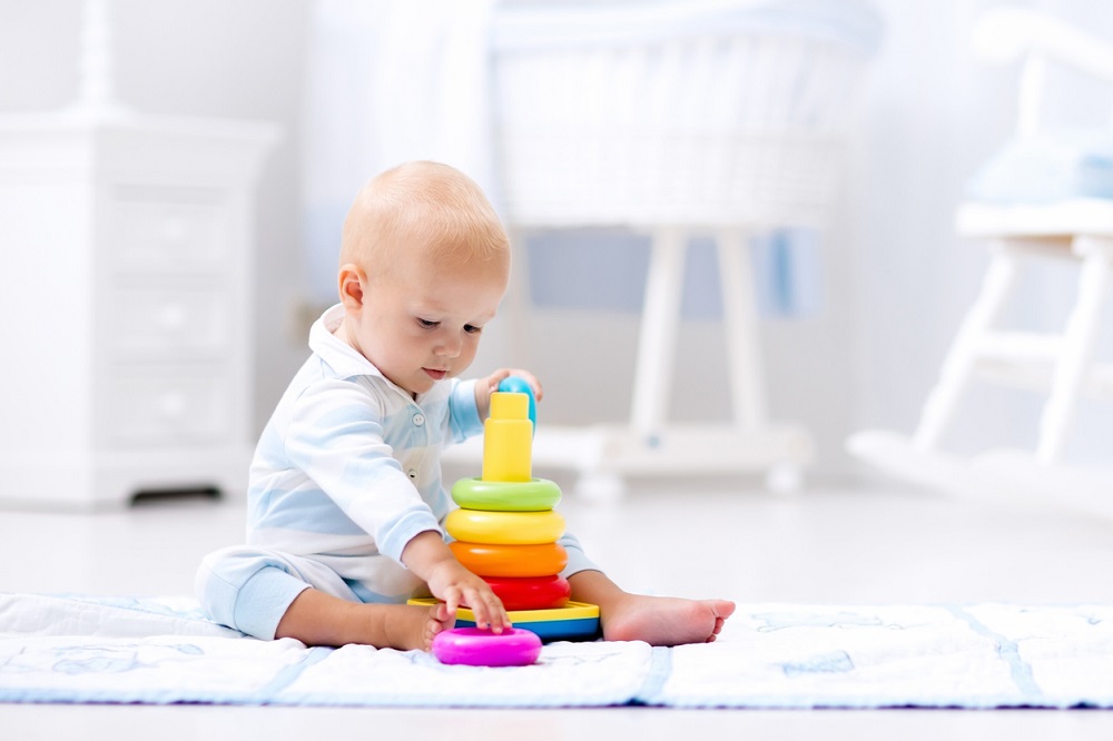 Toddler playing with stacking toy
