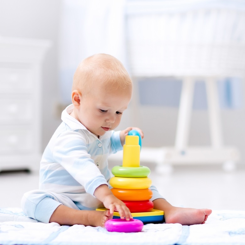 Toddler playing with stacking toy