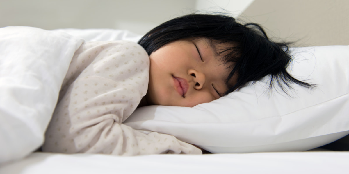 photo of toddler asleep in bed