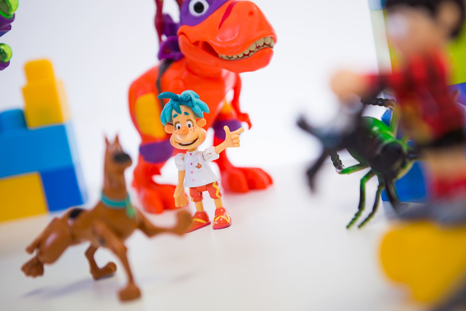 Image of small, brightly coloured toys on a table.