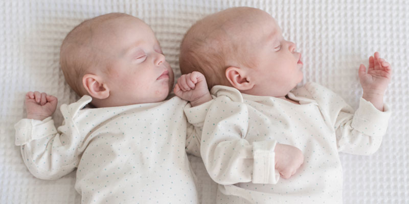 Baby twins sleeping side by side