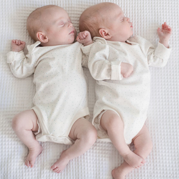 Baby twins sleeping side by side